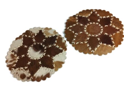 2 pieces of Cowhide Patchwork round Table Mats marked vintage hand laced